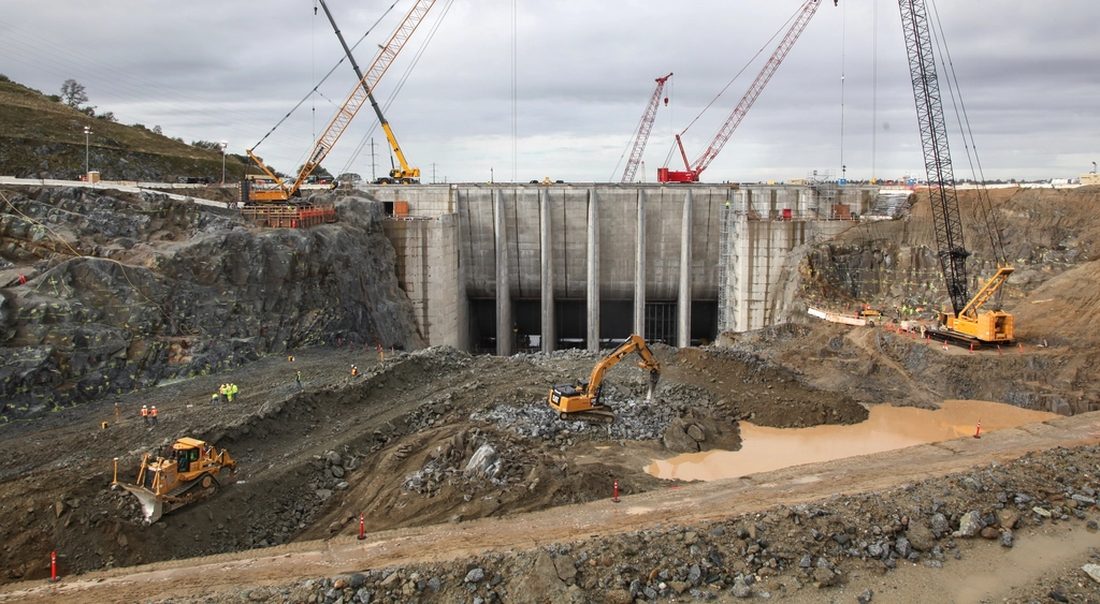 Large civil works site with cranes and excavators