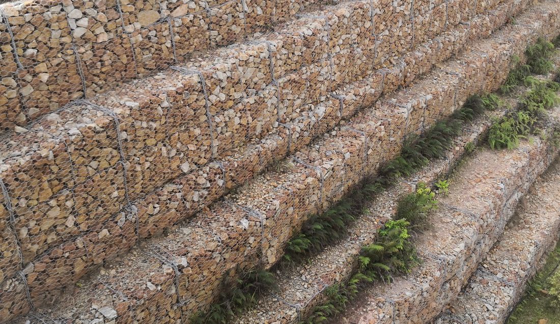 Engineered gabion retaining wall stabilising a slope