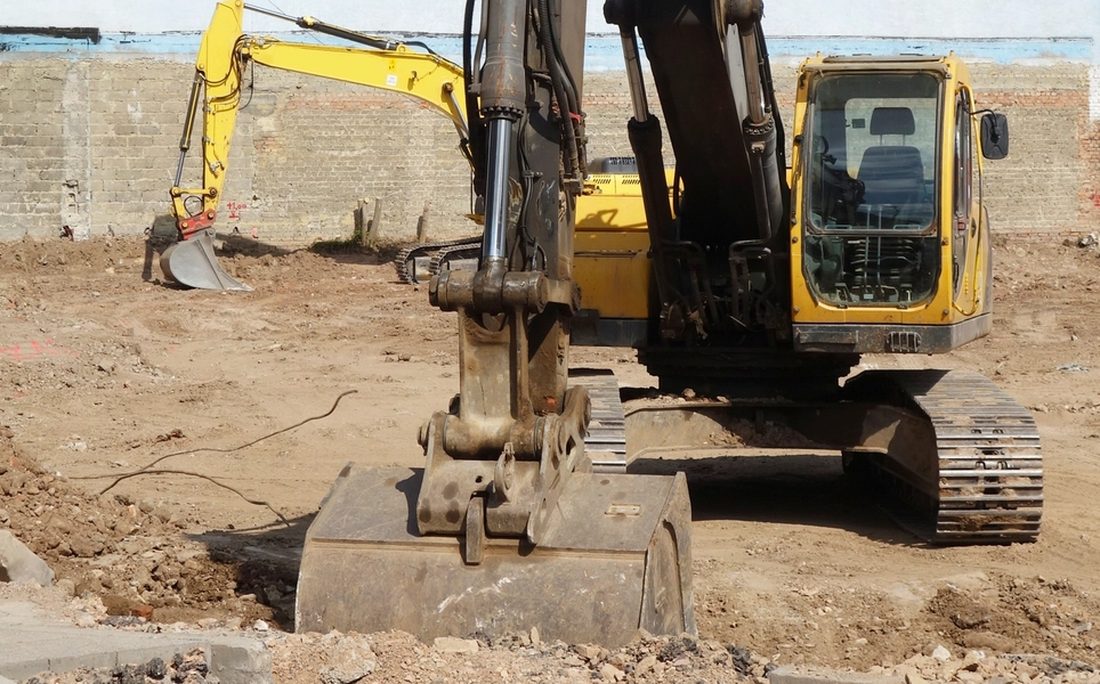 Excavators working a cleared development site